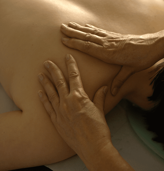 Therapist giving a relaxing back massage to a client.