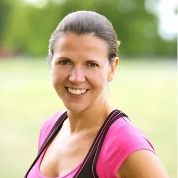 Smiling woman in casual athletic wear outdoors.
